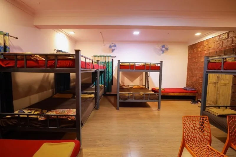 Dormitory with bunk beds and a brick feature wall