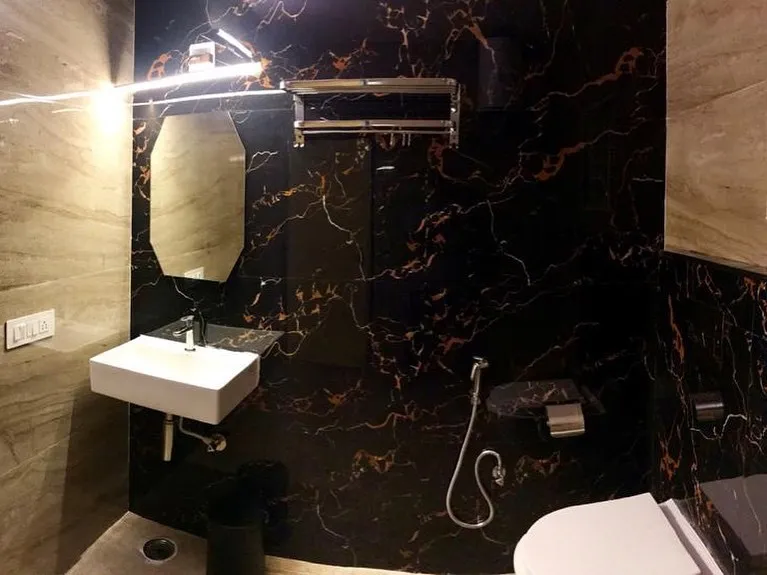 Bathroom with dark marble-look walls